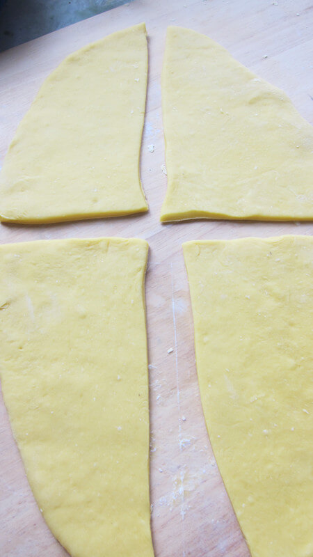 Press the fermented dough into a thick slab with a noodle stick.