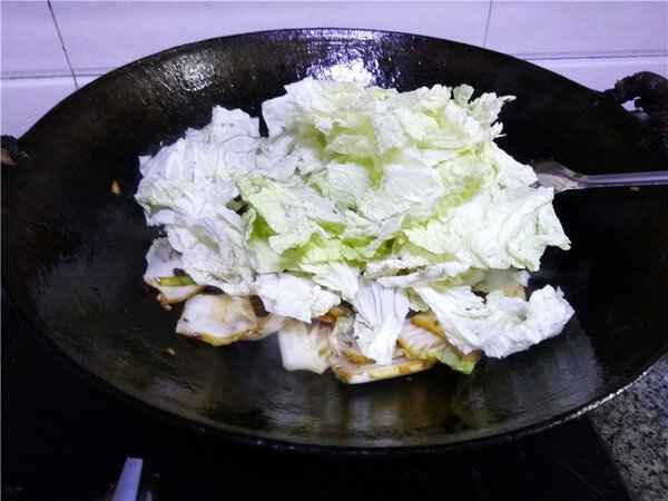 Add cabbage leaves and continue to stir fry;