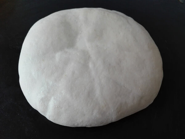 Cover and wrap the whole cake with the remaining large piece of dough