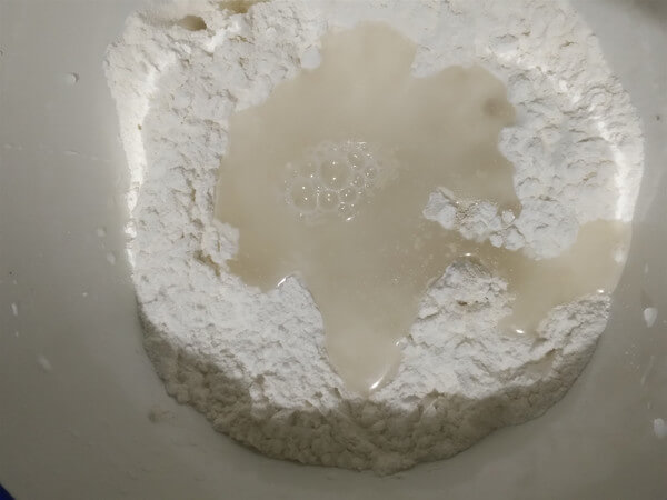Add warm water to the powder.