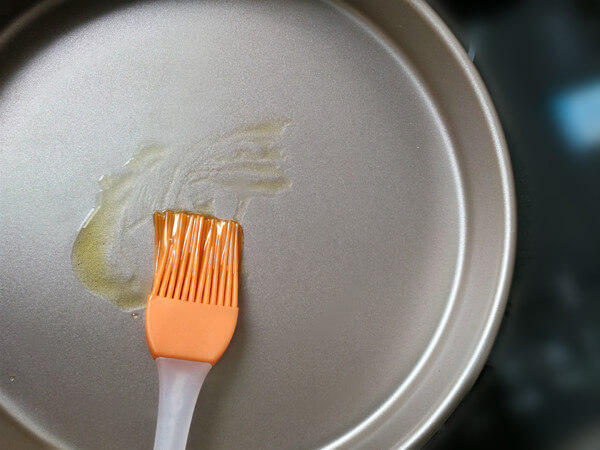 Brush olive oil on the pizza tray to prevent sticking.