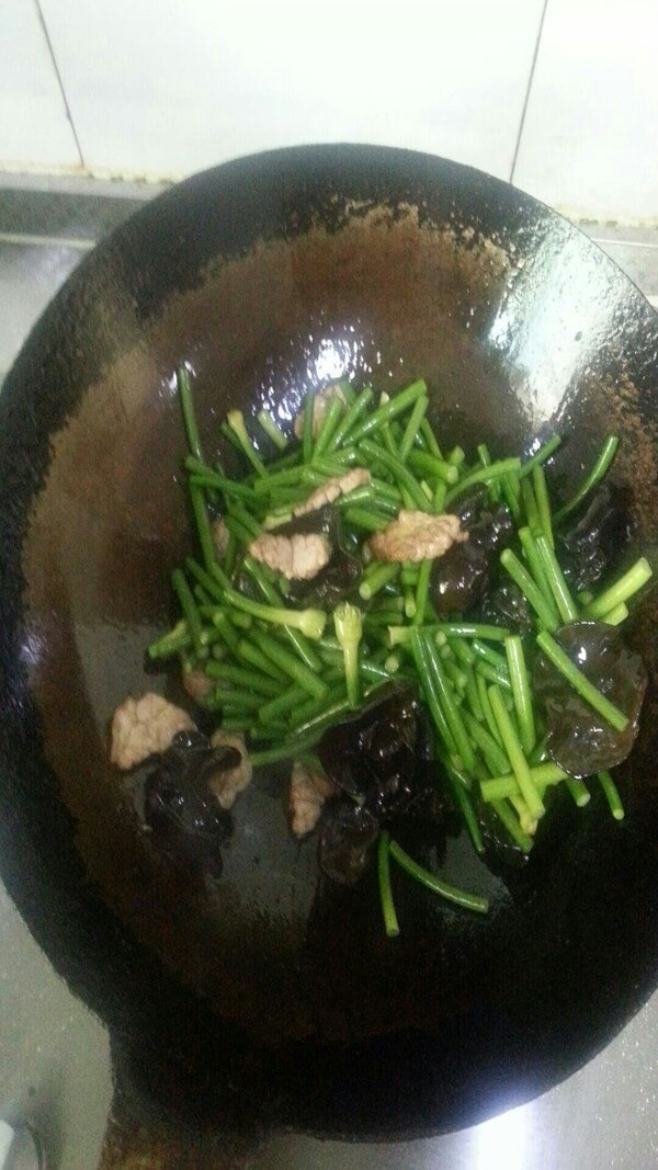 Add garlic sprouts, salt and stir-fry