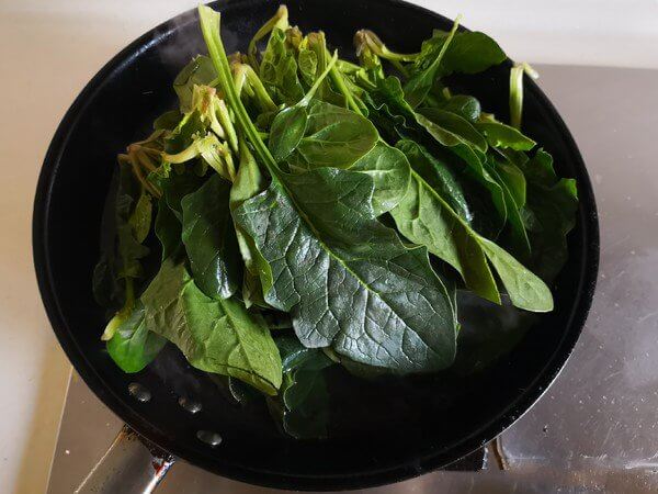 Put the spinach in the pot and blanch