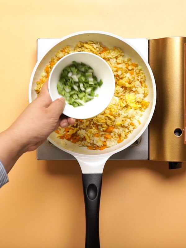 Pour the greens and stir fry evenly