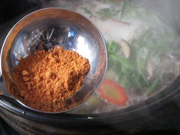 Put a spoonful of Tom Yum Kung soup