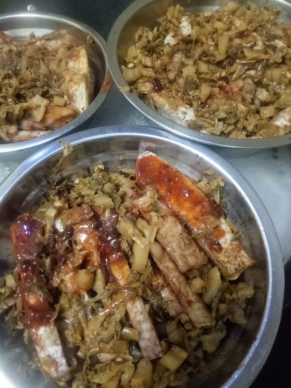 In a large deep-mouthed bowl, the pork belly is facing down,