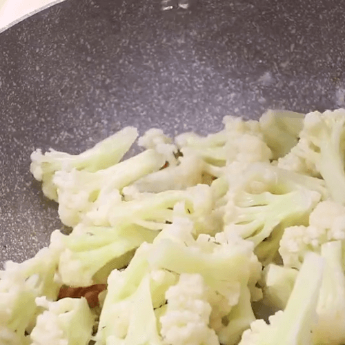 Pour in cauliflower and stir fry evenly