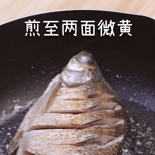Wuchang fish fried in a pan until slightly yellow on both sides