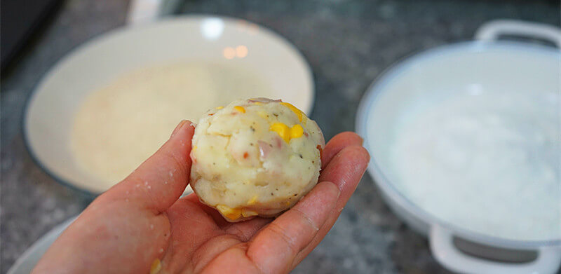 Grab an appropriate amount of mashed potatoes in your hand,