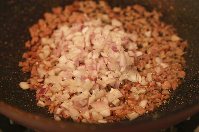 Throw in the onions and fry them for a while, add a little pepper and season with salt