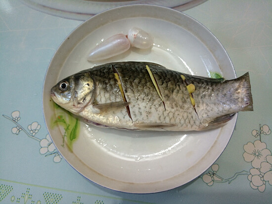 Put a few slices of ginger in the fish belly, and a slice of ginger in the diagonal knife.