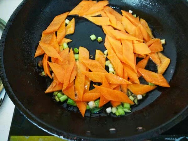Sauté carrot slices first and add green onion