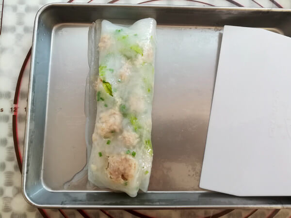 Use a scraper to shovel the rolls from one side
